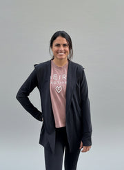 woman wearing an open cardigan activewear jacket with matching leggings and a Meira Active t-shirt against a light grey background