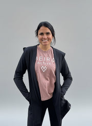 woman wearing activewear consisting of an open cardigan and legging set and Meira Active T-shirt standing against a light grey background